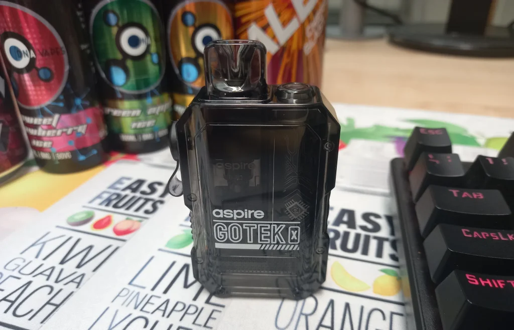 Black Aspire GoTek X Vape Kit in front of bottles of e-liquid.