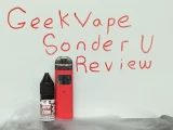A vape kit in front of a whiteboard that has Geekvape Sonder U Review written on it
